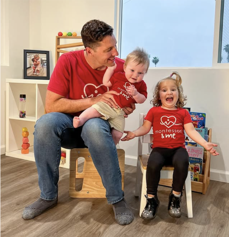 Andrew and his kids celebrating the sale of Montessori & Me